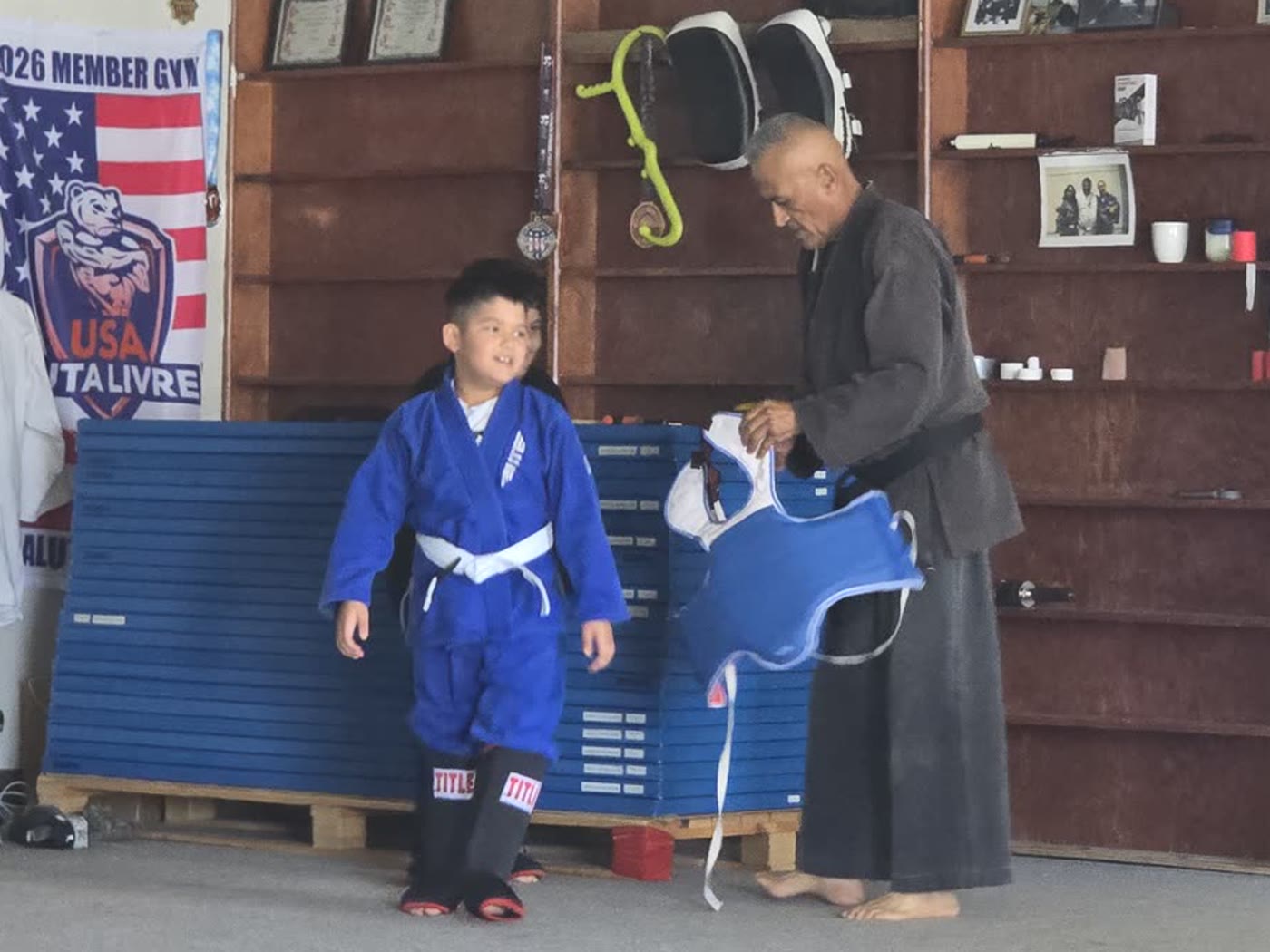 Young student working pad drills with an instructor
